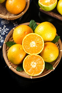 Fresh Zigui Oranges from Hubei China in Wicker Basket with Cut Pieces Showing Vitamin Rich Orange Flesh