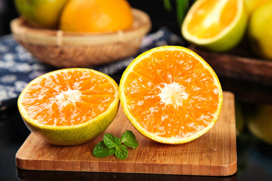 Fresh Cut Zigui Oranges from Hubei China Showing Rich Orange Flesh and Vitamin Content on Wooden Board