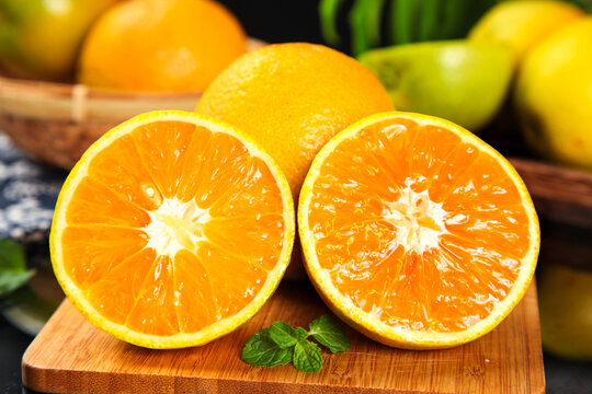 Fresh Orange Halves Cut on Wooden Board Showing Juicy Flesh with Citrus Fruits from Zigui Hubei China