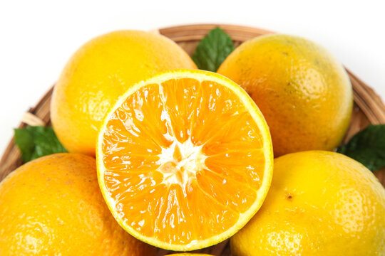Fresh Cut Orange from Zigui Hubei China Showing Juicy Flesh and Segments in Wicker Basket Studio Shot