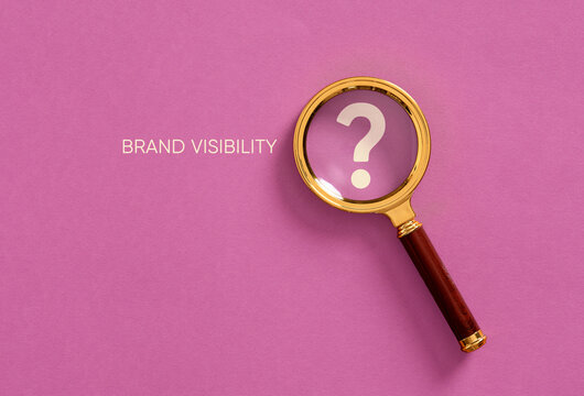 Brand visibility and awareness concept with magnifying glass examining a question mark