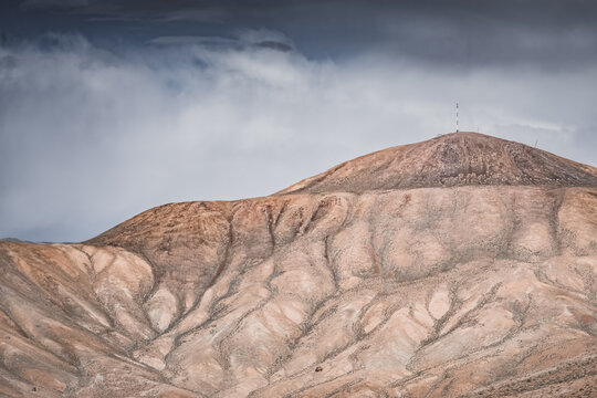 Rocky mountain slopes in the Pamir Mountains in Tajikistan, a minimalist landscape and rocky hills in sunny weather