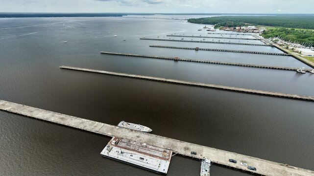Aerial view of the long concrete piers of the Reynolds Park Yacht Center extending into the St. Johns River under an overcast sky Green Cove Springs, Florida, United States.