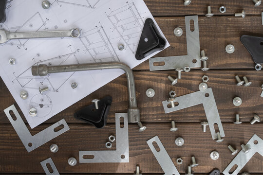 Metal shelving assembly process with bolts, nuts, brackets, tools and instruction manual. Suitable for furniture installation, home improvement and storage organization themes.