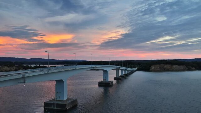 Aerial view of Noto Bridge at twilight with purple sky over Nanao Bay Japan