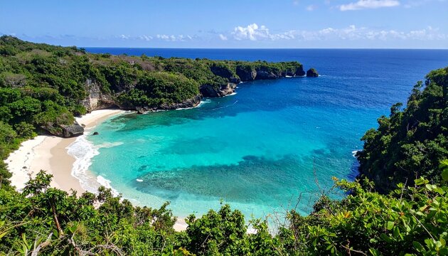 A stunning tropical lagoon surrounded by cliffs, emerald water, white sand, and lush vegetation
