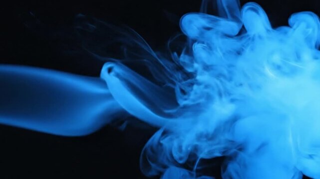 Blue smoke swirling on a dark background with a cloudy texture video