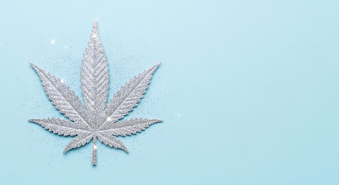Sparkling Silver Cannabis Leaf Resting on Pale Blue Background