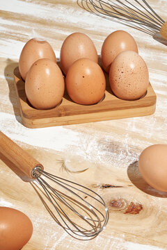 Natural Brown Eggs in Rustic Bamboo Wooden Egg Holder for Home Baking Breakfast Preparation Farm Fresh Ingredients and Sustainable Kitchen Traditions