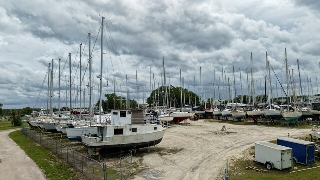Aerial view of sailboats on dry storage stands in a boatyard under a dramatic cloudy sky Green Cove Springs, Florida, United States.