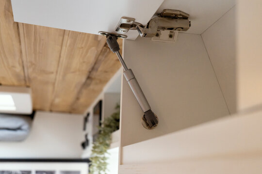 
Spring hinge for a camper van cabinet.
Articulated fitting that allows a camper van cabinet to be opened and closed safely.