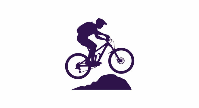 Silhouette of a person on a mountain bike jumping over a dirt mound