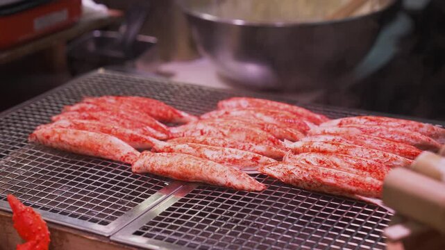 Cooking Hot Crab Stick Seafood on Grill at Asian Street Food Market