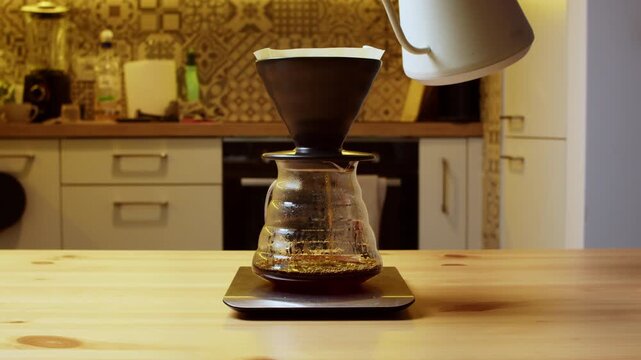 Slow motion pour over coffee brewing in ceramic dripper