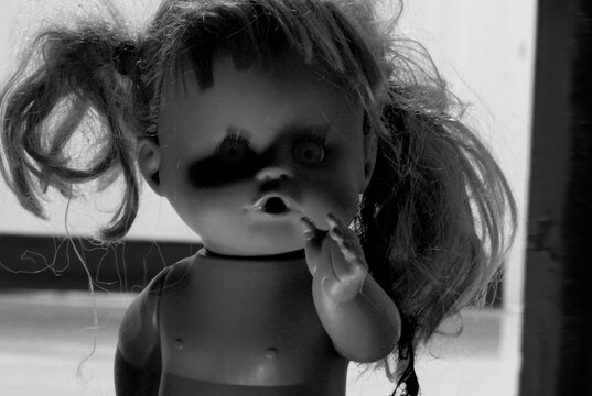Horror shot: a scary doll on the floor,halloween night,horror doll in black and white picture style