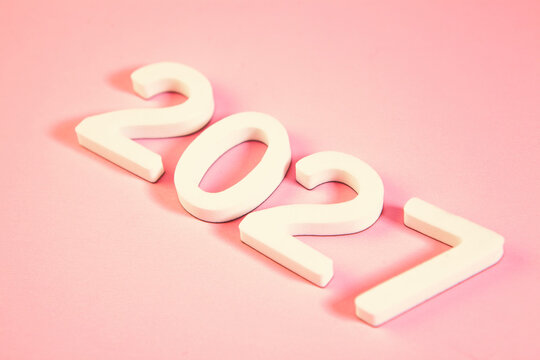 New Year and Christmas concept. White wooden numbers 2027 on pink background