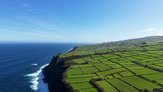 Drone panorama of patchwork agricultural fields along dramatic Atlantic coastline on Terceira Island in the Azores Portugal