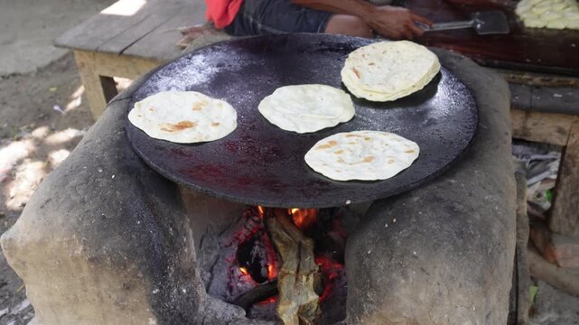 Traditional roti cooking on wood fire tawa