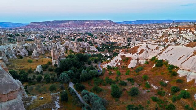 Drone view of Goreme, Cappadocia, Turkey town. Cave homes, rocky valleys and fairy chimneys show a famous historic destination.