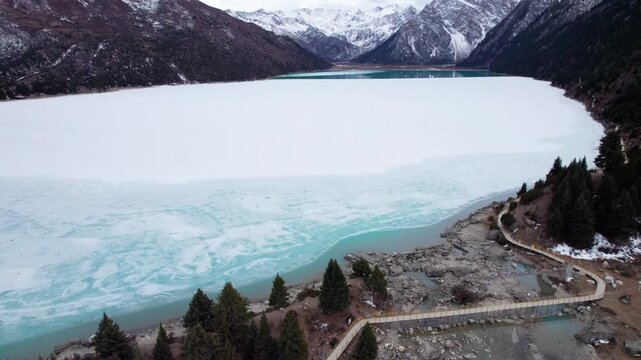 Drone view of Xinluhai lake or Yulong Lhatso in Tibetan, alpine glacial holy lake in Dege County, Garze Tibetan Autonomous Prefecture, Sichuan, China, 4k real time footage, travel concept.