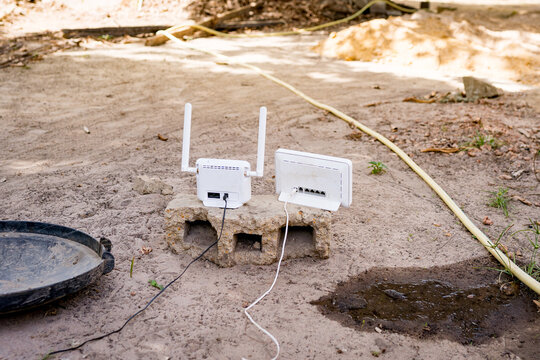 Internet router and modem seen in african garden outdoors, concept of connectivity and web infrastructure in africa