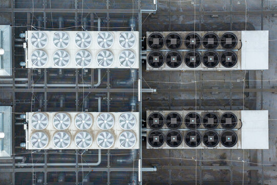 Aerial view of the industrial HVAC cooling system and ventilation fans on the rooftop of Centrum Technologii ICM UW Siedziba C in Warszawa, Mazowieckie, Poland.