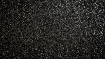 Fototapeta premium Black textured surface showing many small sparkles in a uniform pattern across the whole area