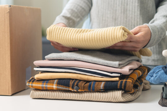 Organize closet and storage concept, people prepare unwanted old fashion clothes for share donation.