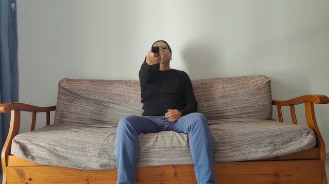 Monster watching tv celebrating victory with remote control