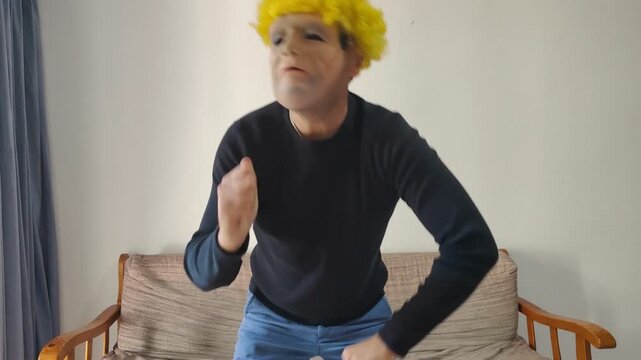 Person wearing funny old man mask and wig dancing