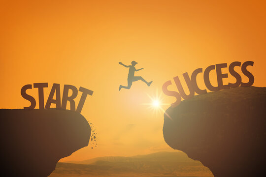 Male person jumps across a gap between start and success against gold sunset sky, sun and landscape background
