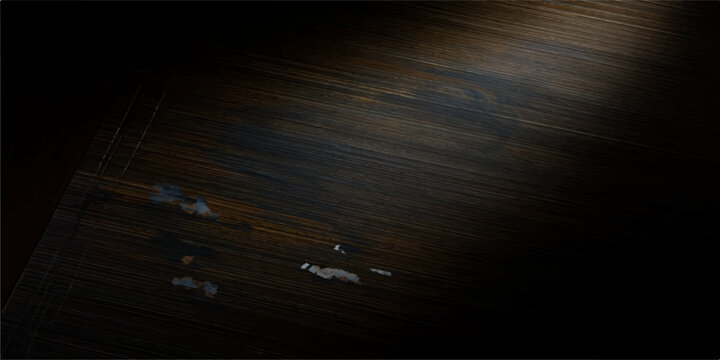 A vintage movie film projector lens rests upon a dark, textured wooden board surface with a natural brown grain pattern