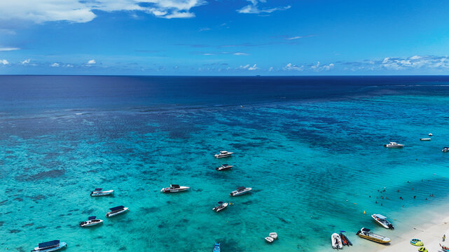 Aerial view of boats anchored in the turquoise water along the white sand beach under a clear blue sky Trou-aux-Biches, Pamplemousses District, Mauritius.