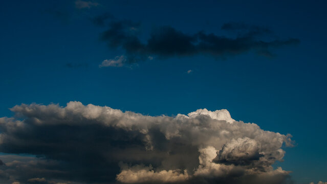 Dark gray rain clouds in the evening sky banner.
