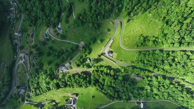 Aerial top-down view of hairpin switchback road on green Col de Spandelles mountainside