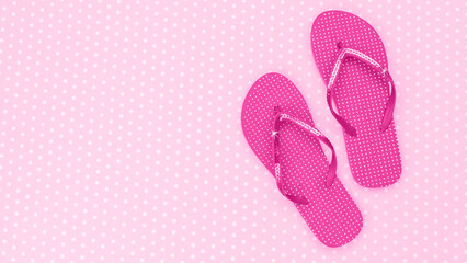 Bright pink flip flops on a polka dot background for summer fun and relaxation © Fleuronica