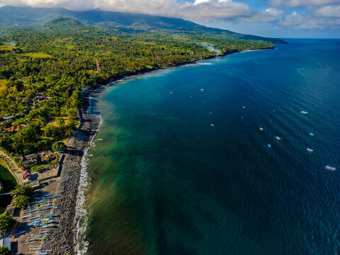 Aerial view of the volcanic coastline and turquoise waters in Amed on the island of Bali