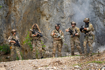 Fototapeta premium Military training exercise rocky terrain action scene outdoor environment tactical perspective preparedness concept