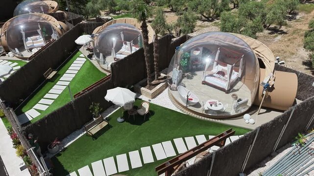 Luxury glamping dome resort in Cazorla with modern bubble tents and outdoor terraces, aerial