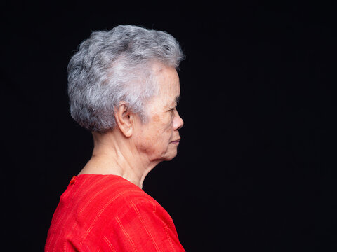 Senior Woman Side Profile Portrait on Dark Background
