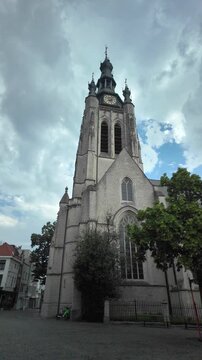 Sint Maartenskerk church tower in Kortrijk Belgium with forward moving vertical camera shot
