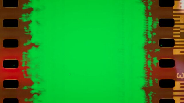 Retro celluloid negative border with green screen display featuring damaged edges and distressed looks abstract cinematic background video editing motion graphics footages clip assets design.