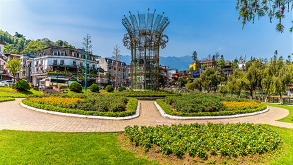 Naklejka premium A panorama view from the south shore across the garden of Sapa Lake Square in Sapa, Vietnam, in the morning