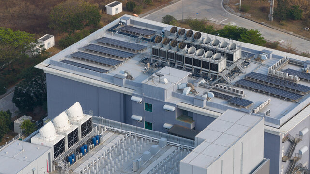 Aerial view of NTT Global Data Centers Thailand Limited featuring rooftop solar panels and industrial cooling systems in Tambon Don Huaro, Chang Wat Chon Buri, Thailand.