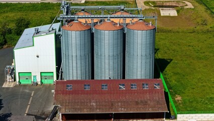 Aerial View of Modern Grain Silos and Farm Buildings in Rural Germany © Maik