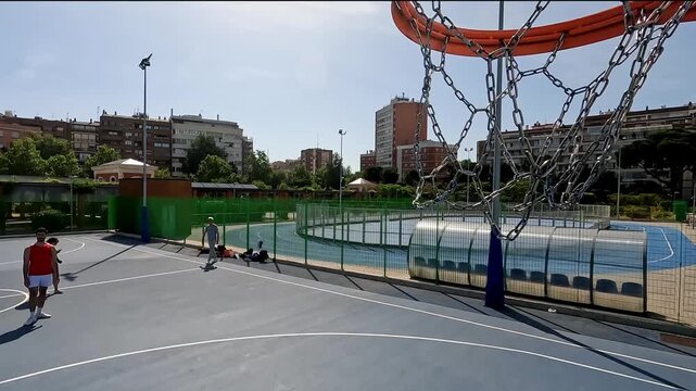 Player scoring a three point shot in an outdoor urban court