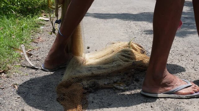 The man caught many fish using a cast net