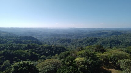 Fototapeta premium Lush Green Hills and Vast Blue Sky Over Serene Mountain Landscape in a Peaceful Natural Setting