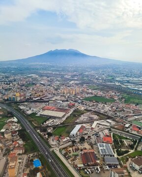 Mount Vesuvius towering over metropolitan Naples aircraft view