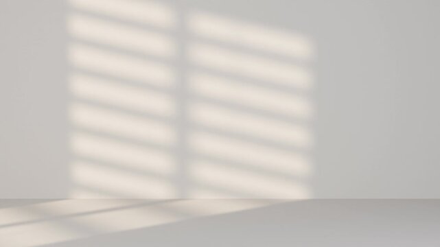 Minimalist interior background with soft moving shadows from window blinds. Gentle sunlight glides across a neutral wall and surface, creating a calm, modern atmosphere with elegant copy space.